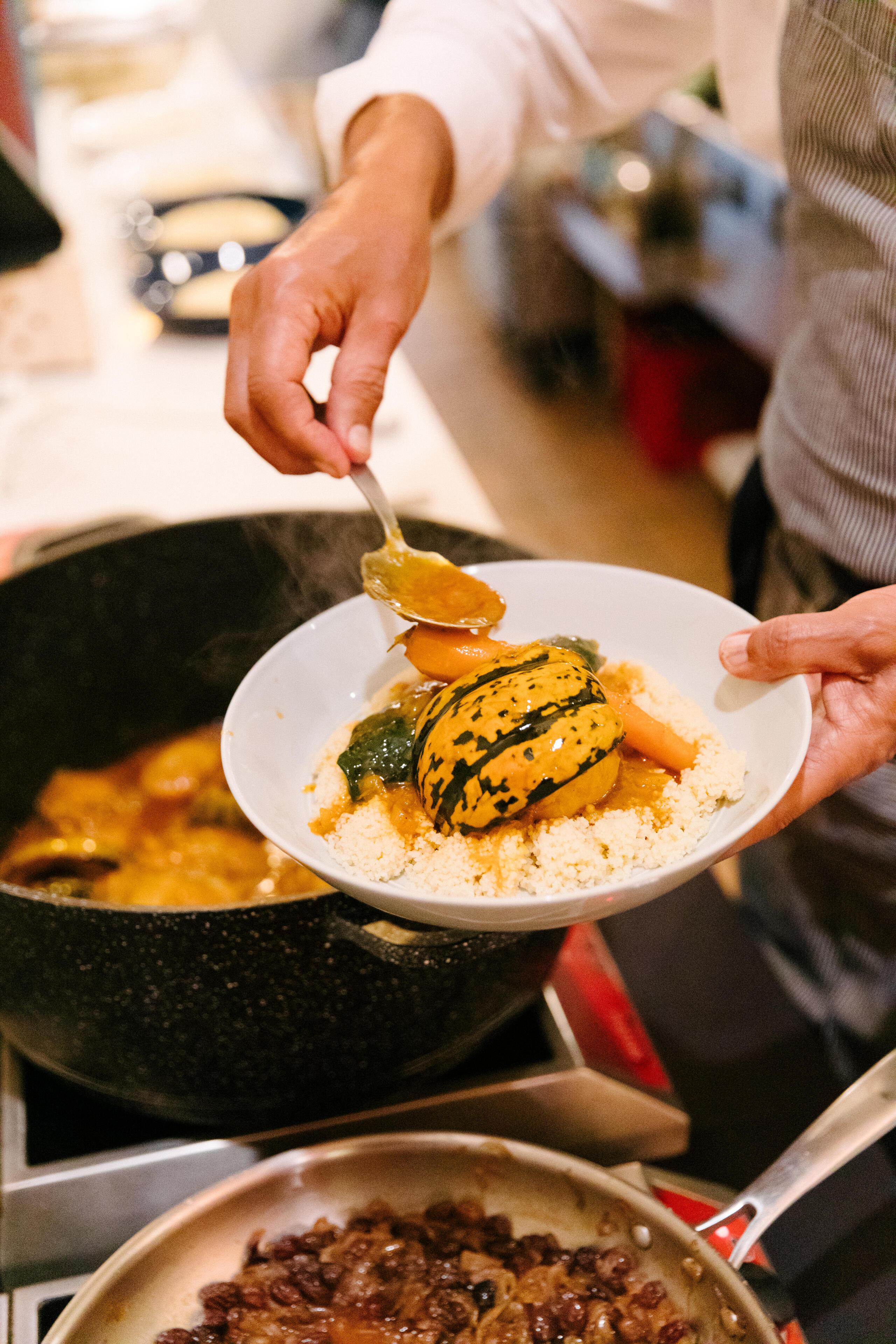 Chef Moulay plating Carnival squash couscous.